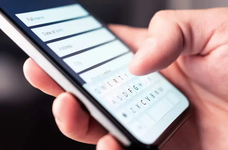 Person typing information to online web form to get a roofing estimate